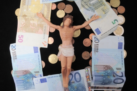 Jesus Christ and Money on a Dark Background - Religion Conceptの写真素材