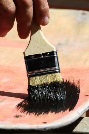 Restoring an Old Vintage Skateboard with Black Paintの写真素材