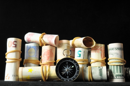 Orientation in  Business Compass and Money on a Black Backgroundの写真素材