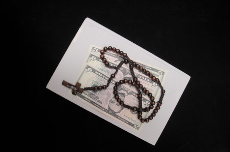 Jesus Christ and Money on a Dark Background - Religion Concept
