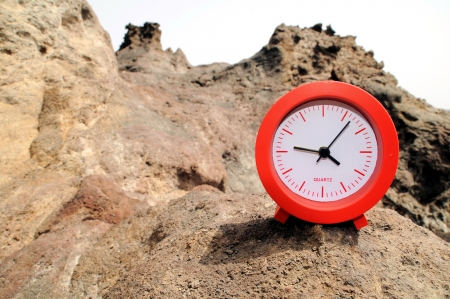 One Red Clock on the Rocks Near the Ocean の写真素材