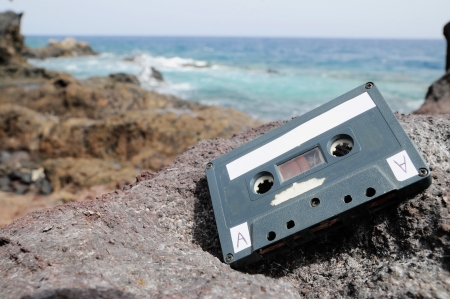 Ancient Retro Musicassette on the Rocks near the Beachの写真素材