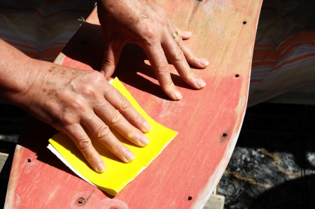 Restore an Old Skateboard with a Yellow Sandpaperの写真素材