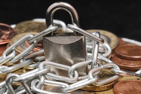 Secure Savings - a Lock and Some Coinsの写真素材
