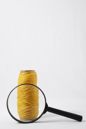 Roll of Twine and Loupe on a White Backgroundの写真素材