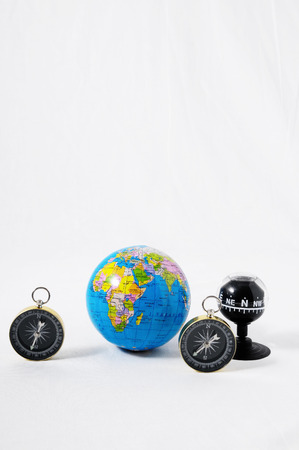 Orientation Concept Earth and Compass on a White Backgroundの写真素材