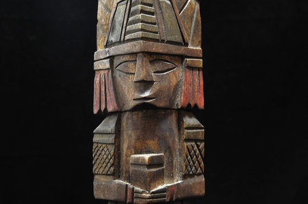 One Ancient Mayan Statue on a Black Background