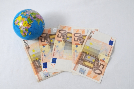 Financial Concept Earth and Money on a White Backgroundの写真素材