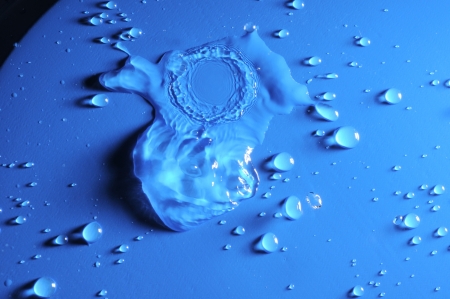 Some Water Drops on a Blue Textured Backgroundの写真素材