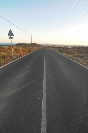 Asphalt Road in the Desert on a Colored Sunsetの写真素材