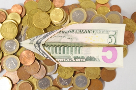 Flying Money Concept a Dollar Airplane and Coinsの写真素材