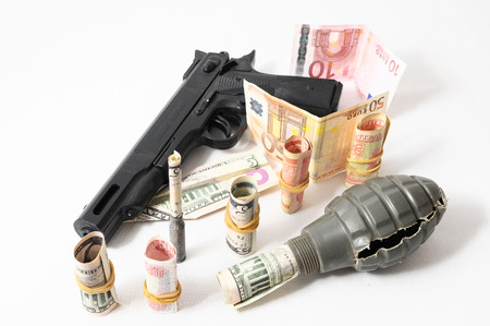 Money and Weapons Concept Weapons and Money on a White Backgroundの写真素材