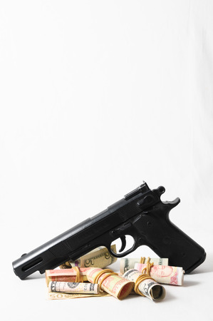 Financial Crime Concept Gun and Money on a White Backgroundの写真素材