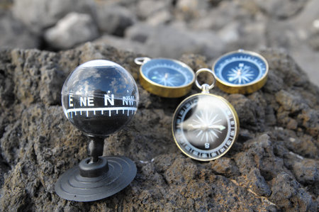 Orientation Concept - Analogic Compass Abandoned on the Rocks