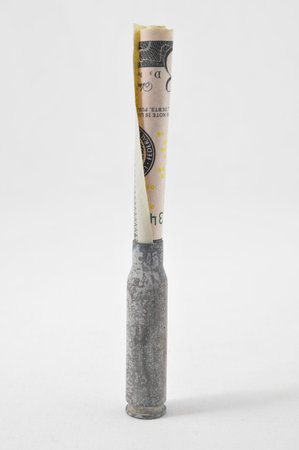 Money and Weapons Concept Bullet and Money on a White Background
