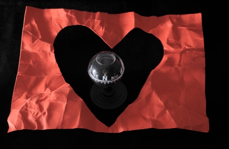 Orientation in Love - Red Paper Heart and Compass on a black Backgroundの写真素材