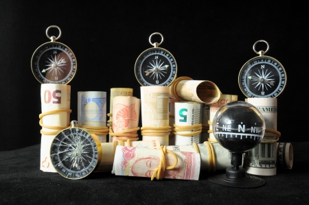 Orientation in  Business Compass and Money on a Black Backgroundの写真素材