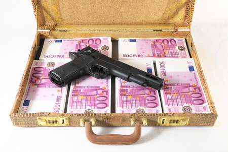 One Suitcase Full of Pink 500 Euros Banknotes and a Gun の写真素材