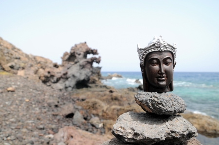 One Ancient Gray Buddha Statue Near The Oceanの写真素材