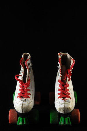 Used Vintage Consumed Roller Skate on a Black Background