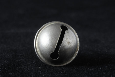 Vintage Small Metal Bell on a Black Background