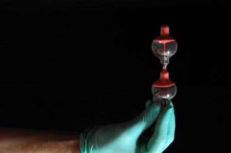 Sand glass And an Hand on a Black Backgroundの写真素材