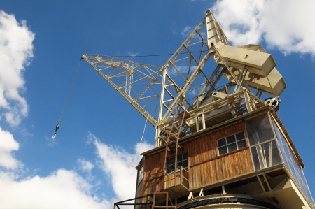 Old Vintage Wooden Port Crane on a Blue Skyの写真素材