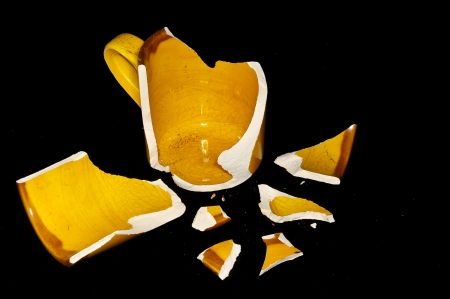 Broken Orange Coffee Cup on A Black Bacgroundの写真素材