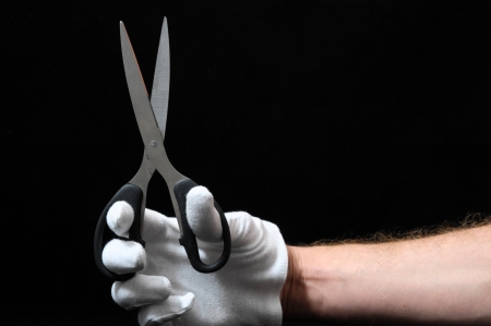 Scissors and Hand on a Black Backgroundの写真素材