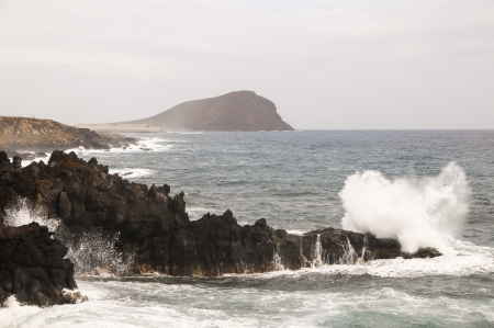 Strong Waves Crashing on the Volcanic Coast in Tenerife Canary Islandsの写真素材