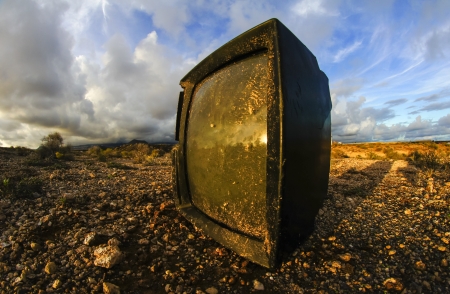 Abandoned Broken Television in the Desert on a Cloudy Dayの写真素材