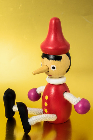 Pinocchio Toy Statue on a Colored Backgroundの写真素材