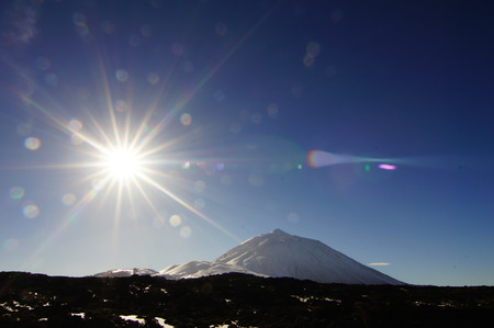 Backlight Sunbeams and Snow on Teide Tenerife Canary Islandsの写真素材