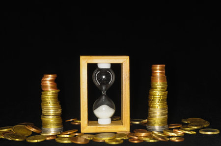 Business Time Concept Hourglass and Money on a Black 