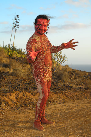 Latin American Man with Long Hairs Masked as a Devil in the Desert