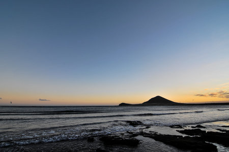 Sunset on the Atlantic Ocean with a Mountain in Background El Medano Tenerife Canary Islands Spainの写真素材