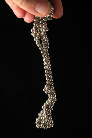 Lot of Round Magnetic Spheres on a Black Background