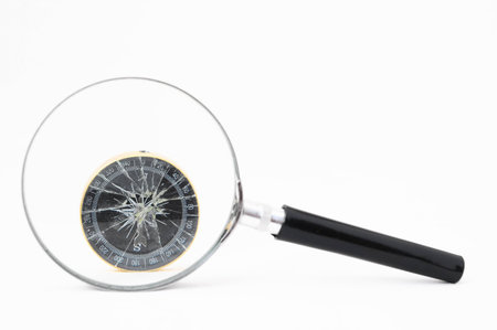 Orientation Concept - Analogic Compass and Loupe on a White Backgroundの写真素材