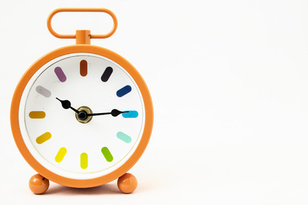 Orange Alarm Clock on a White Backgroundの写真素材