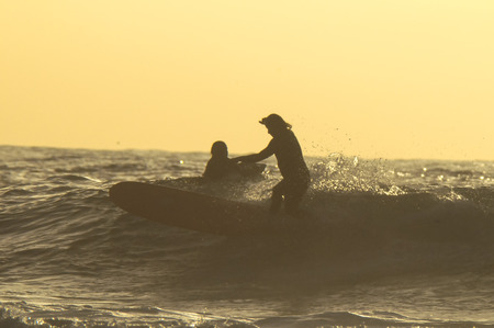 Silhouette Surfer Riding a Big Wave in Tenerife Canary Island Spainの写真素材