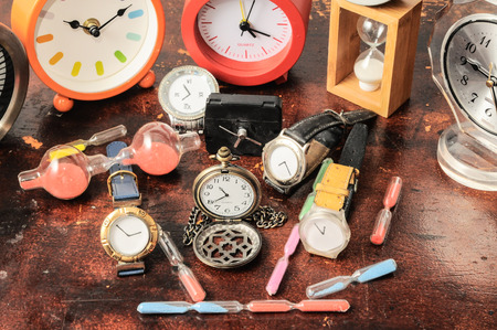 Many Different Clocks on a Woden Tableの写真素材