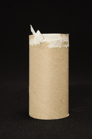 Empty Toilet Rolls Stack Up On a Black Backgroundの写真素材