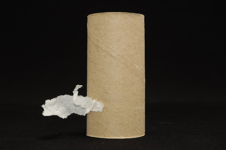 Empty Toilet Rolls Stack Up On a Black Backgroundの写真素材