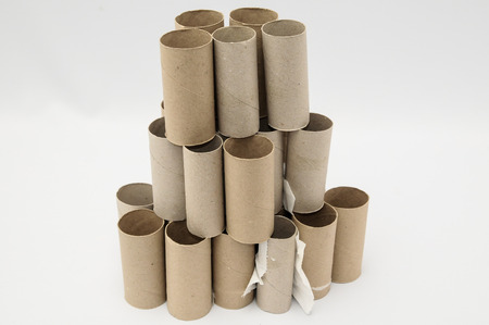 Empty Toilet Rolls Stack Up On a Black Backgroundの写真素材