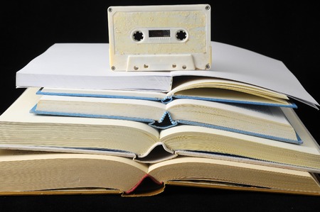 Empty Classic Book and Music Tape Isolated over a Black Backgroundの写真素材