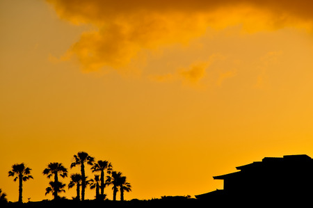 Sunset Scene at Tropical Beach Resort Silhouetteの写真素材