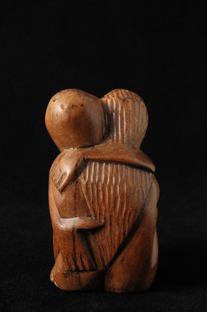 Lovers Sculpture made of Wood on a Black Background