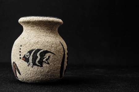 Colorful designed clay vase over a Black backgroundの写真素材