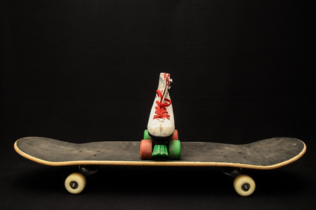 Vintage Style Black Skateboard and Skate Boot on a Dark Backgroundの写真素材