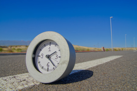 Time Concept Alarm Clock on the Asphalt Streetの写真素材